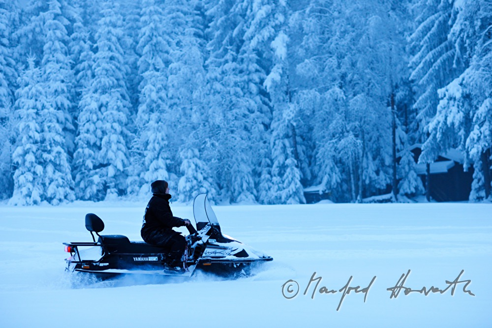 woman rides a snowmobile