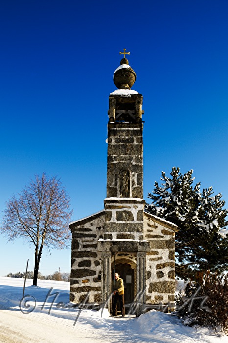 man rings the bells of the villge chapel