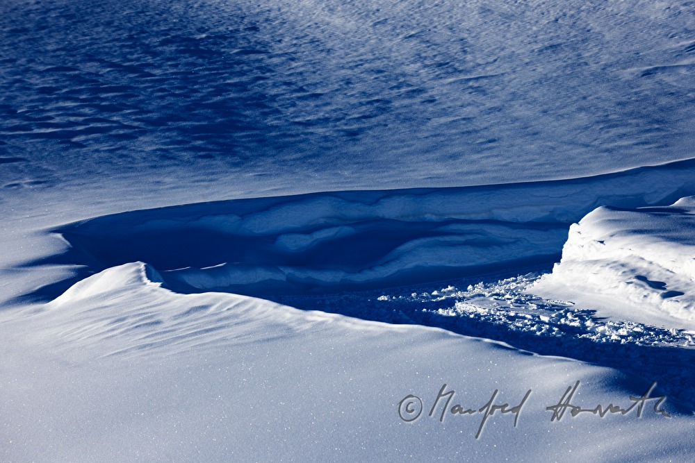 tracks of the ski tourers over the tree line