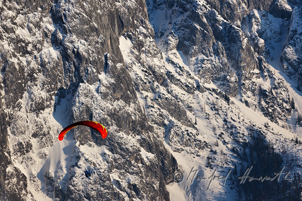 Parglider flies down to the valley