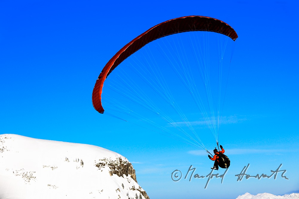 Parglider flies down to the valley