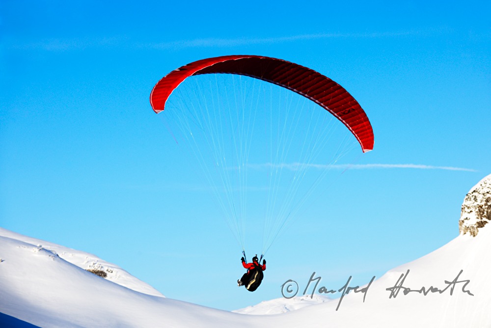 Parglider flies down to the valley