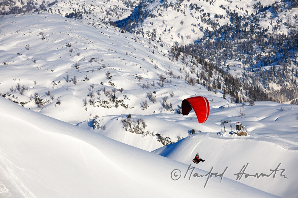 Parglider flies down to the valley