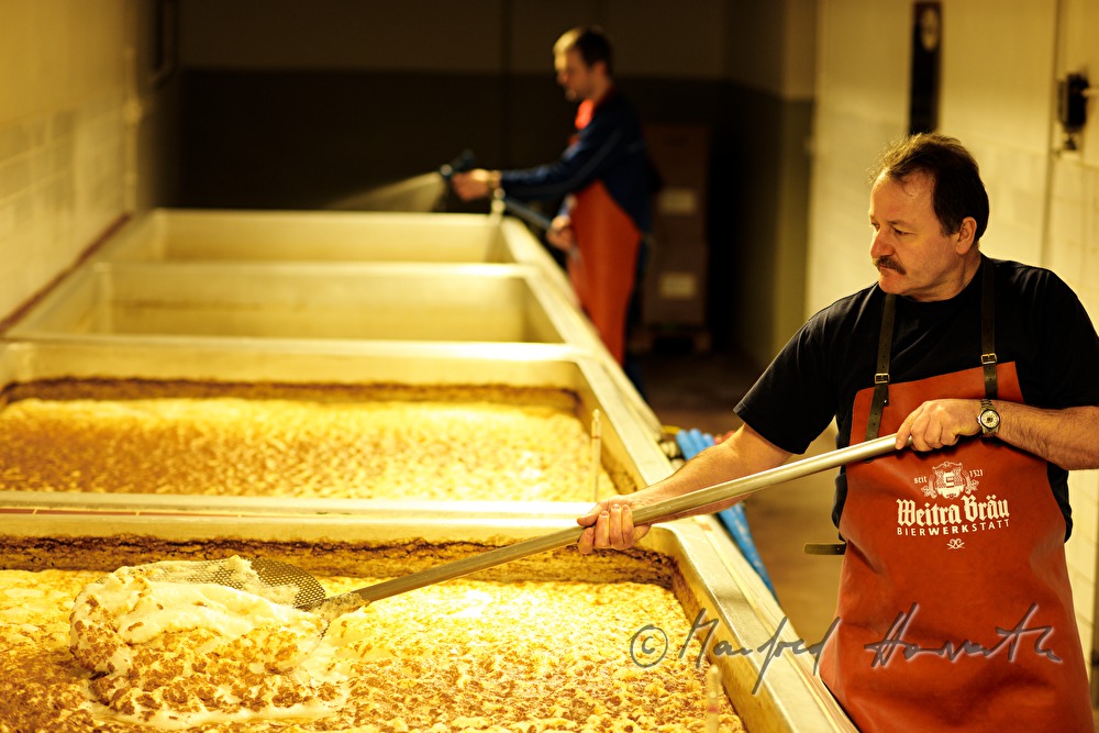 skimming off trub at the fermenting vat