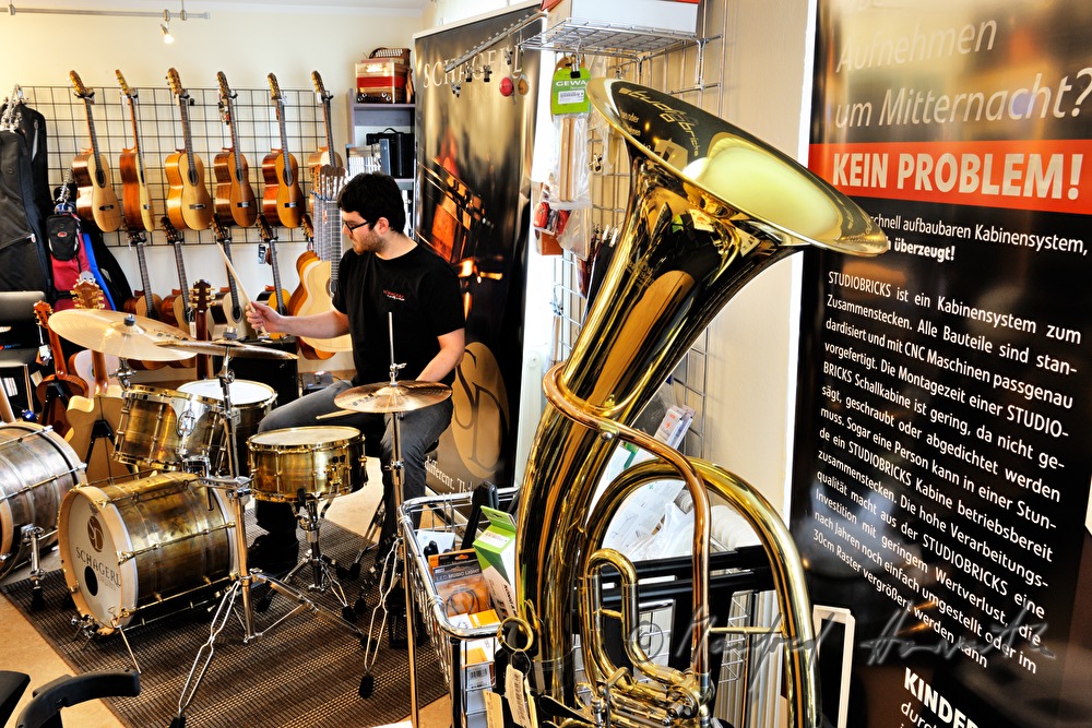 drummer plays a brass drum kit