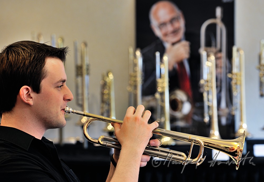 trumpeter plays a trumpet in rehearsal room
