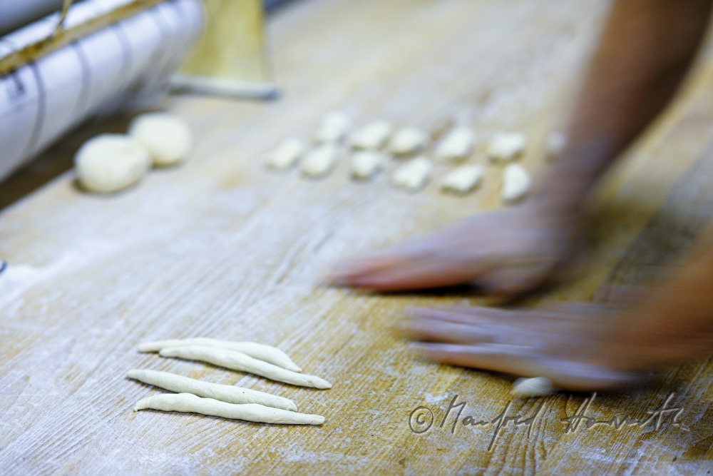 making of hand shaped pretzel rolls