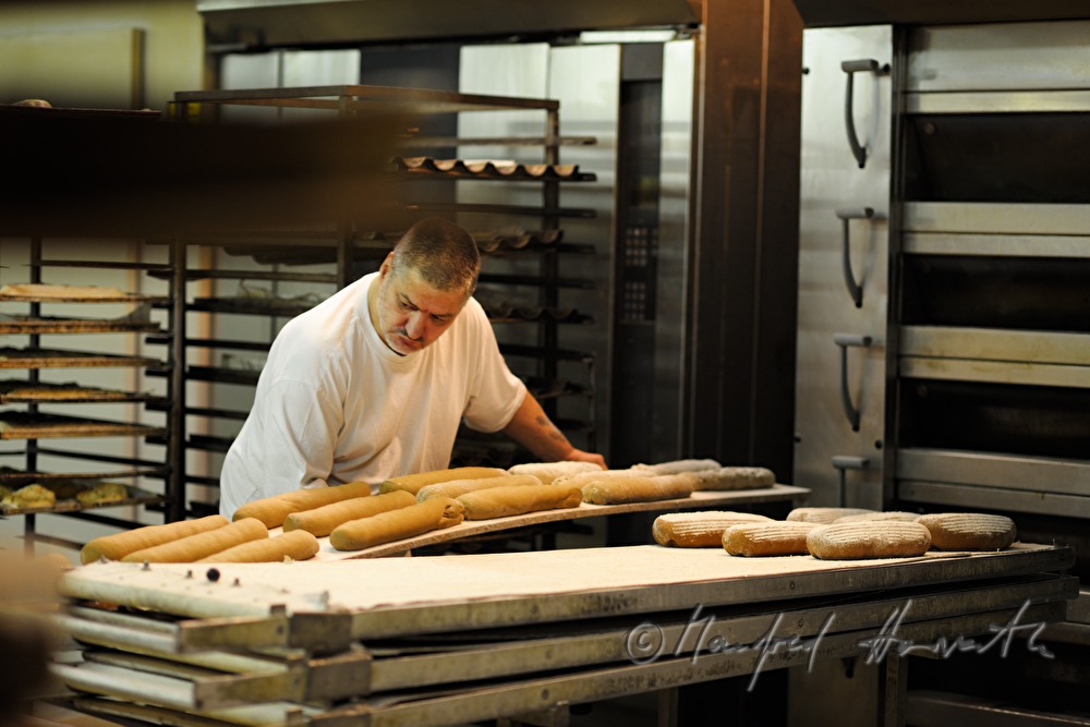 baker shoots in rye bread into the oven