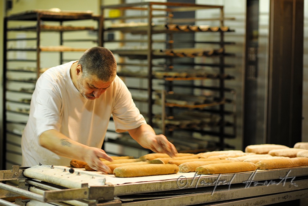 baker shoots in rye bread into the oven