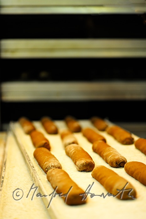 baker shoots in rye bread into the oven