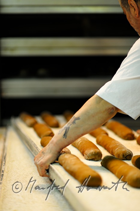 baker shoots in rye bread into the oven