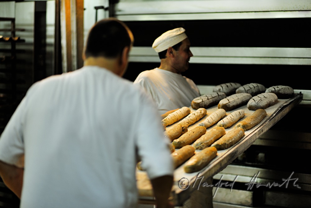 baker shoots in rye bread into the oven
