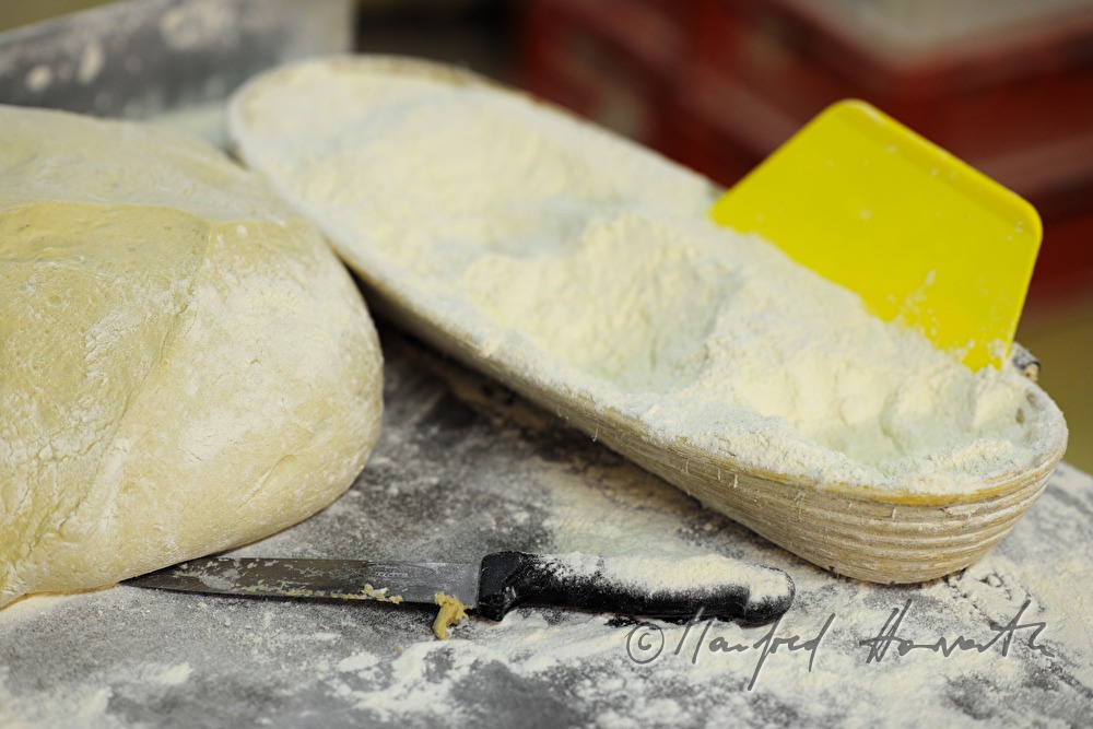workplace with knive, wheat flour and wheat dough