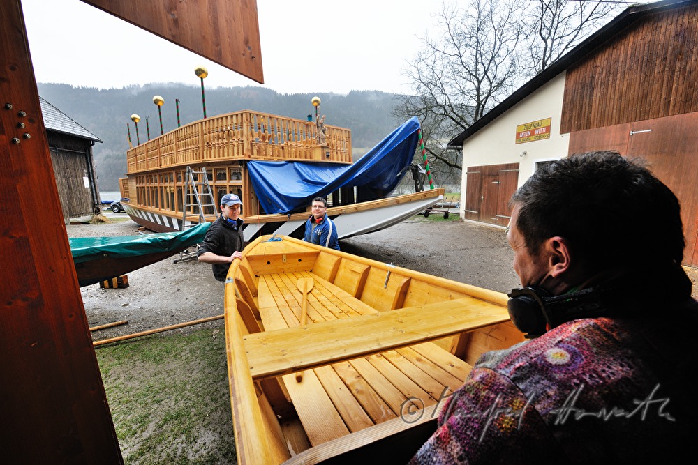 new built barge is being carried into the workshop