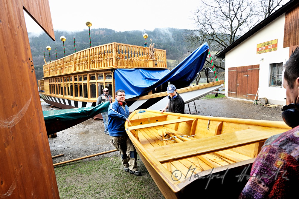 new built barge is being carried into the workshop
