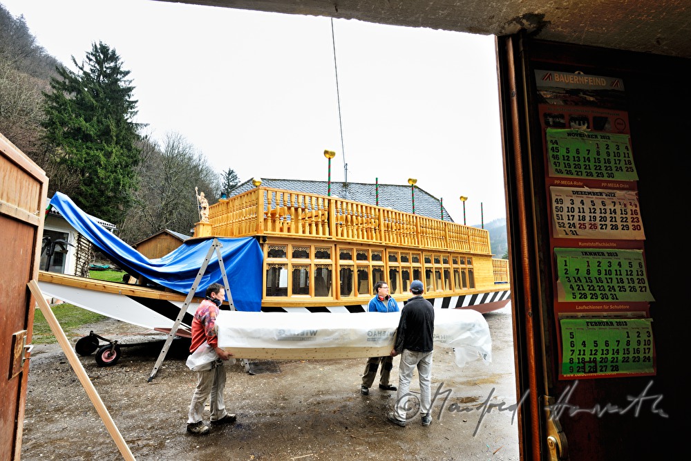 new built barge is being carried into the workshop