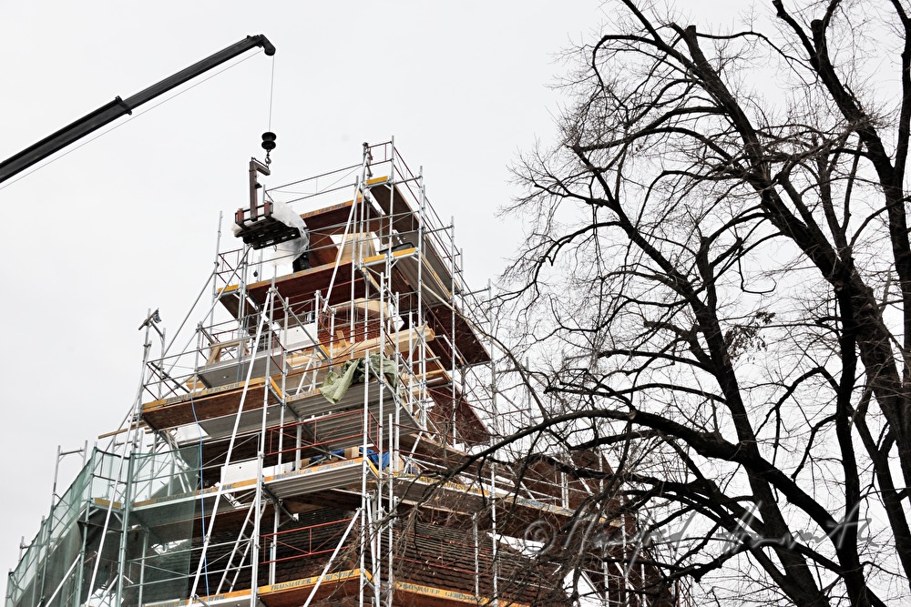 roof tiles are being lifted up to the roofers