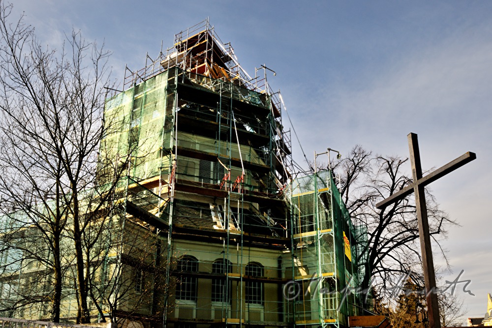 roof tiles are being lifted up to the roofers
