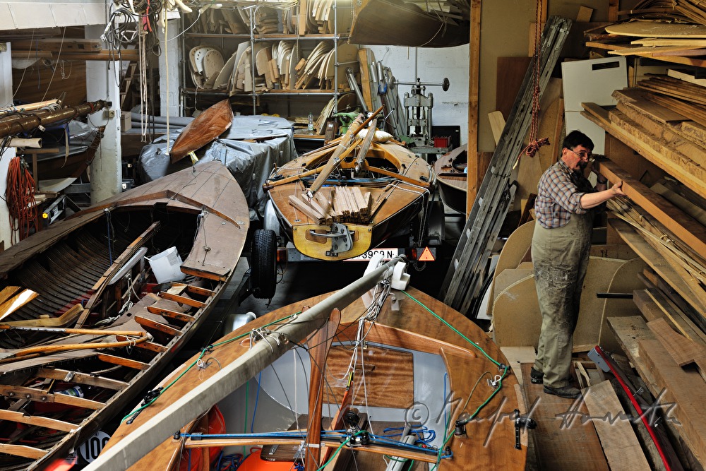 boat builder classifys planks in the store