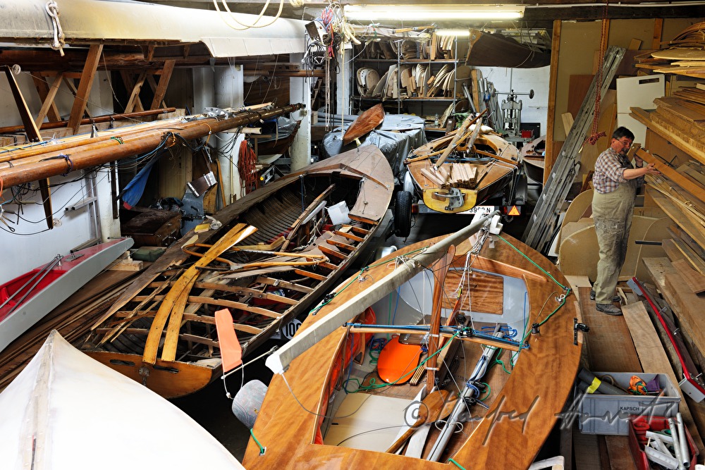 boat builder classifys planks in the store