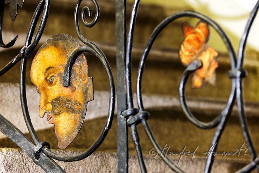 detail of a wroughtiron fence showing heads of turk men