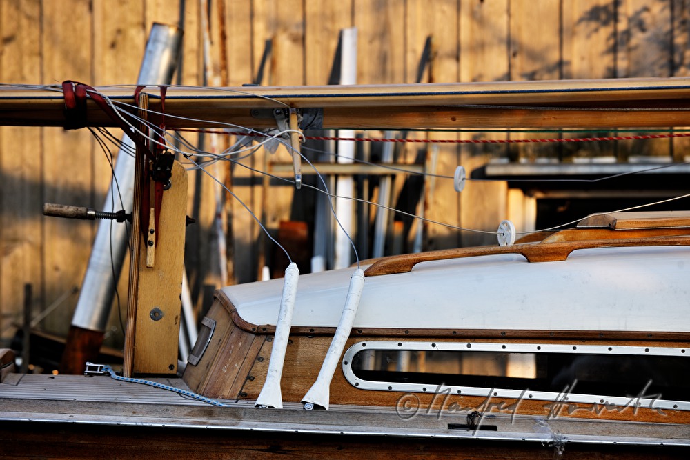 detail of a wooden boat in front of the workshop
