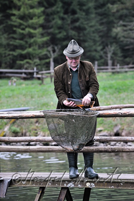 a fisherman is catching chars with a casher