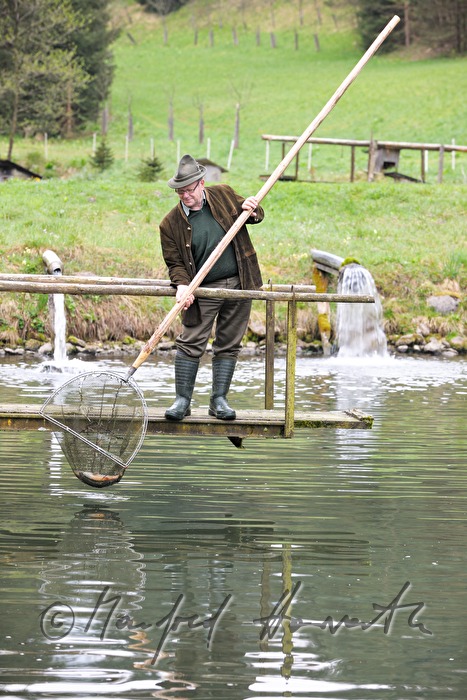 a fisherman is catching chars with a casher