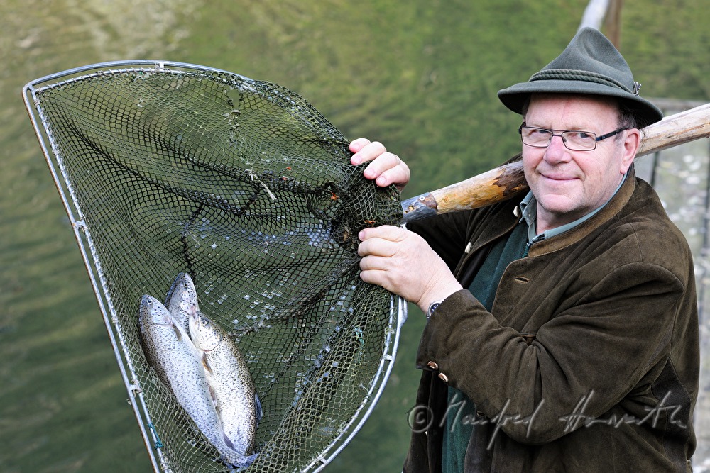 a fisherman is catching trouts with a casher