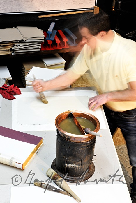 glueing of paper for a handbound book