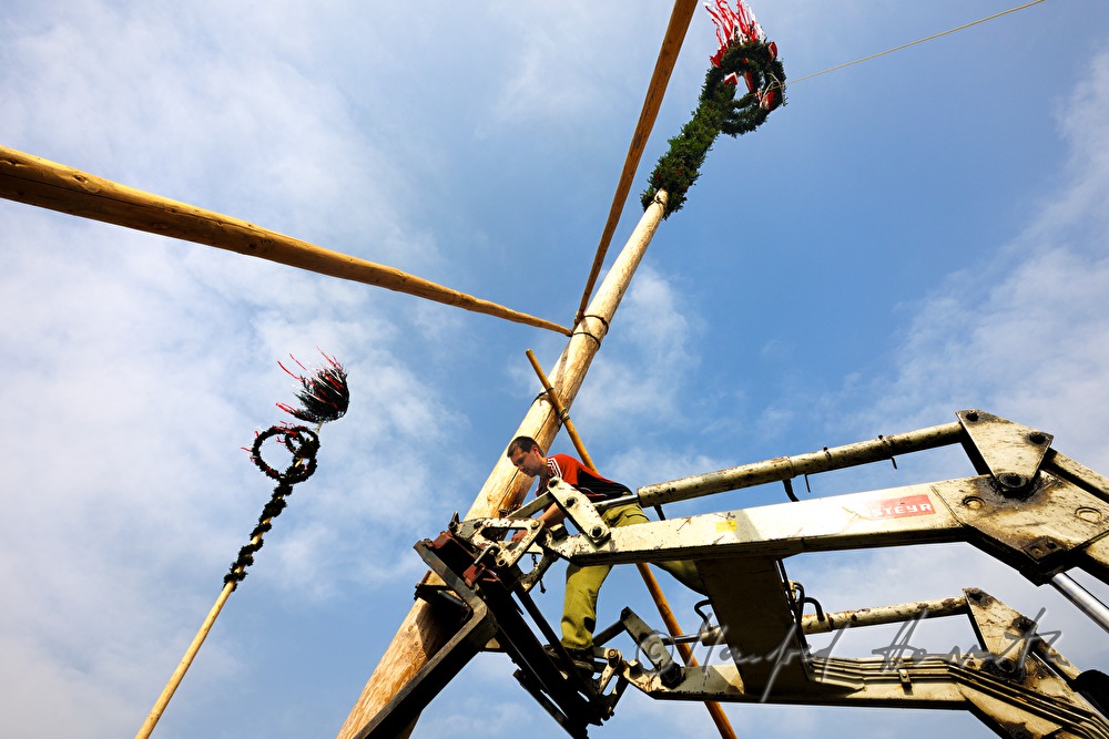 fire brigade erecting a maypole on the 1st of May