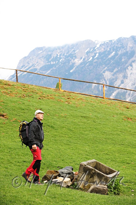 mountaineer near a well on the meadow