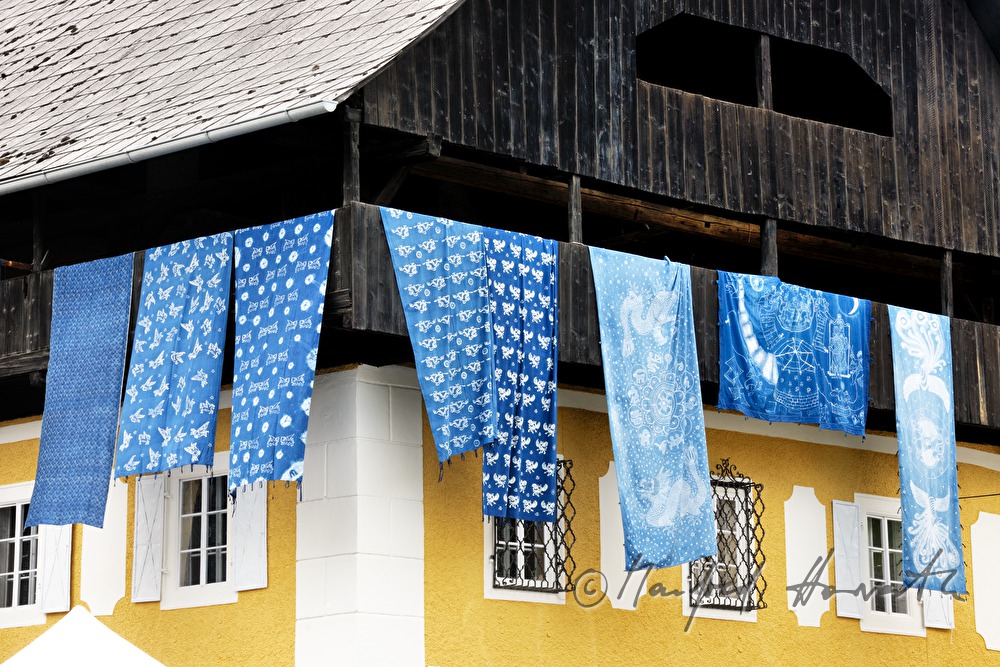 rags printed in blueprint hang op the balcony of the Indigo museum
