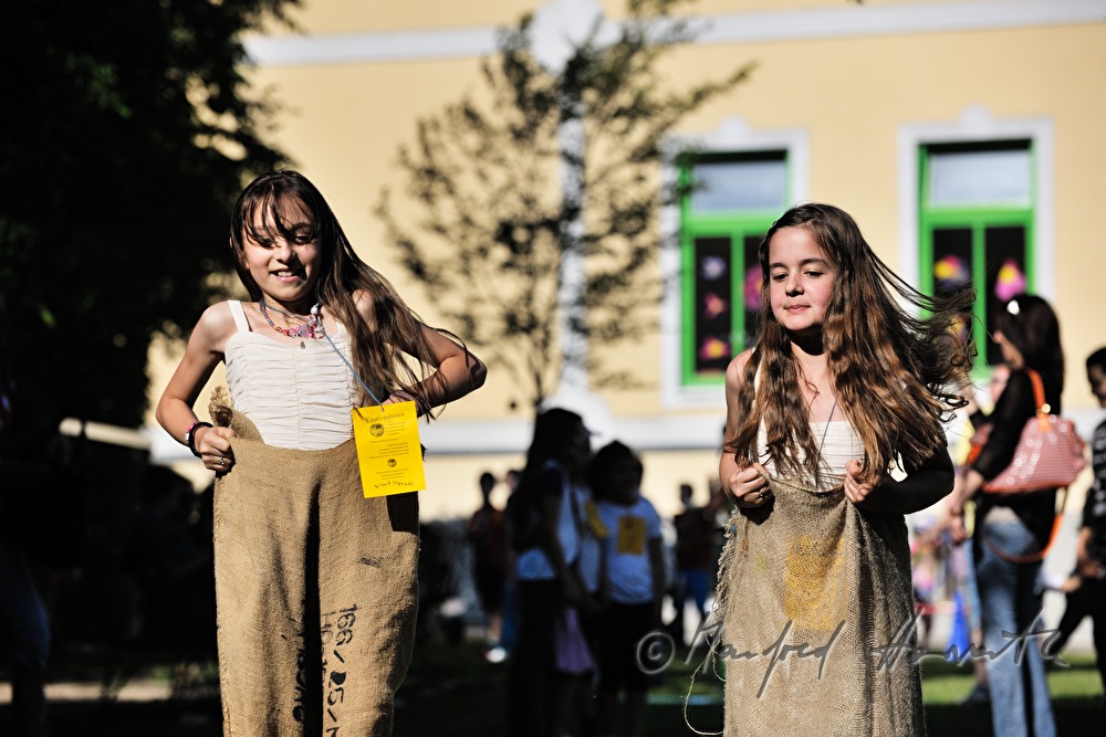 pupils doing a sack race in the school yard
