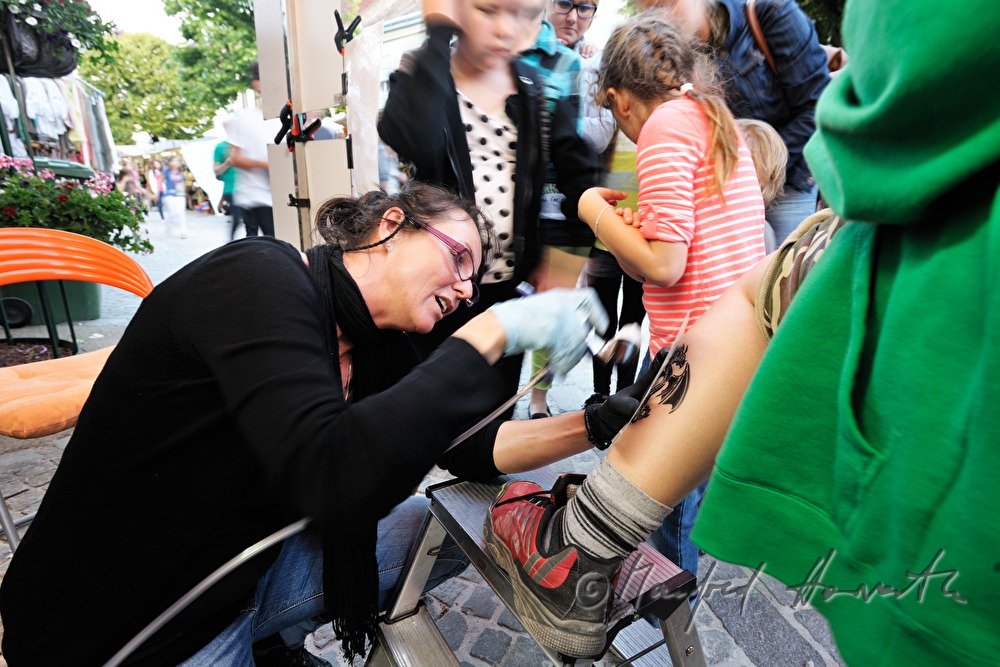 making of a fake tattoo at the booth