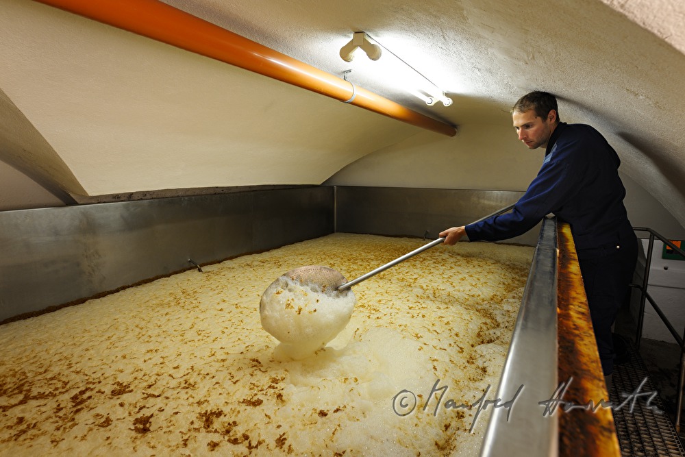 skimming off foam in the fermenting vat
