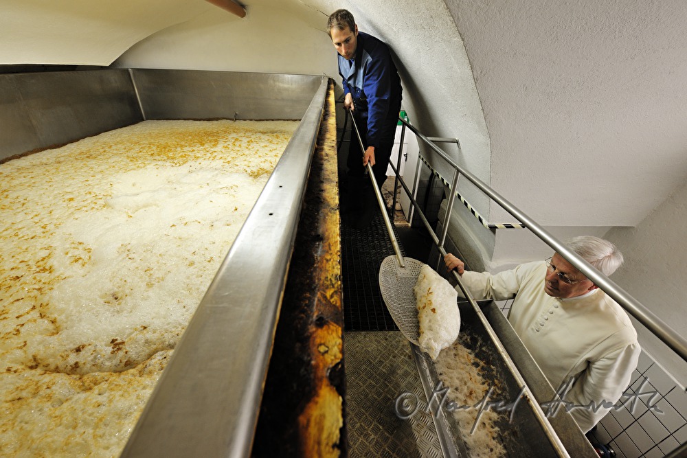skimming off foam in the fermenting vat
