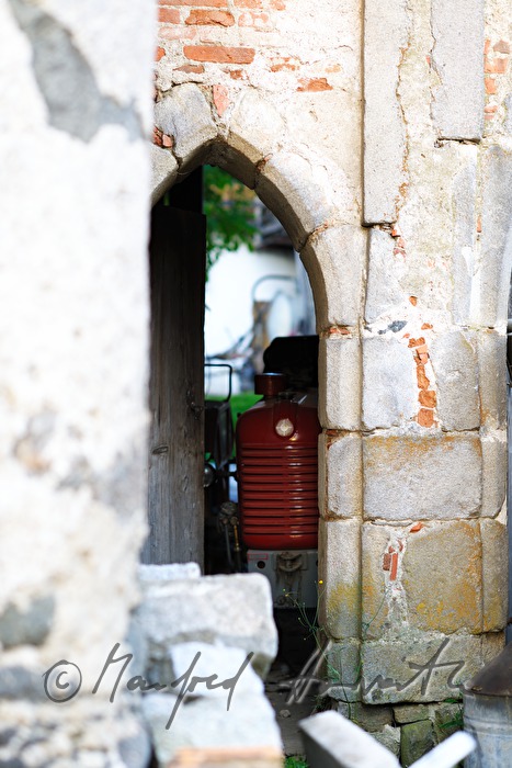 tractor in a garage with a door from the Gothic times