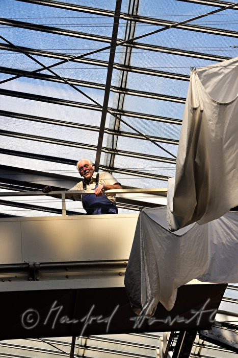 company technician near the openable glass roof and a white curtain