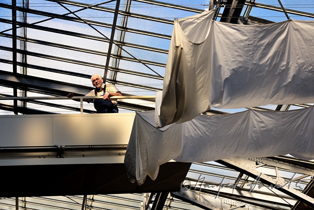 company technician near the openable glass roof and a white curtain