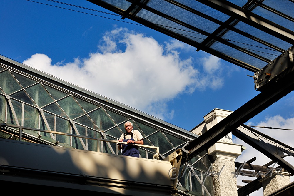 company technician near the openable glass roof and a white curtain