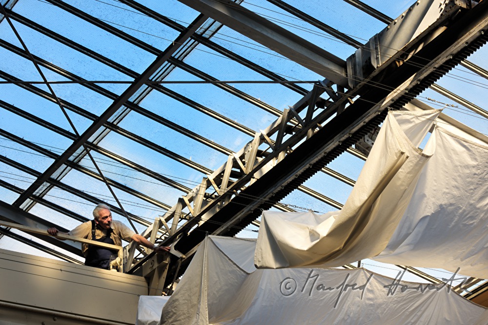 company technician near the openable glass roof and a white curtain