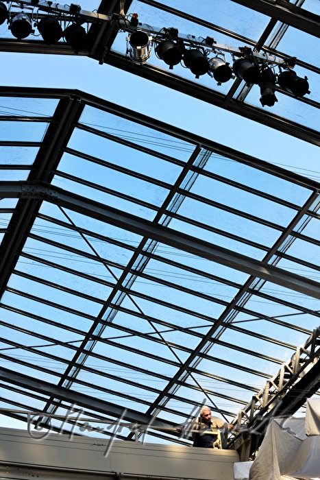 company technician near the openable glass roof and a white curtain