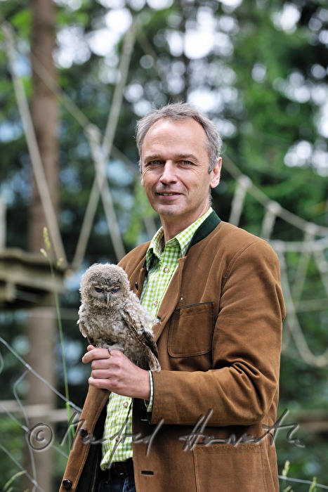 joung barn owl and zoo director in the nature park