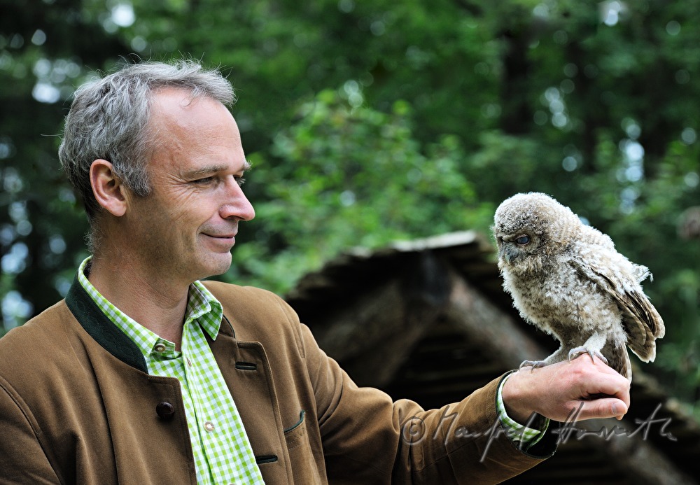 joung barn owl and zoo director in the nature park