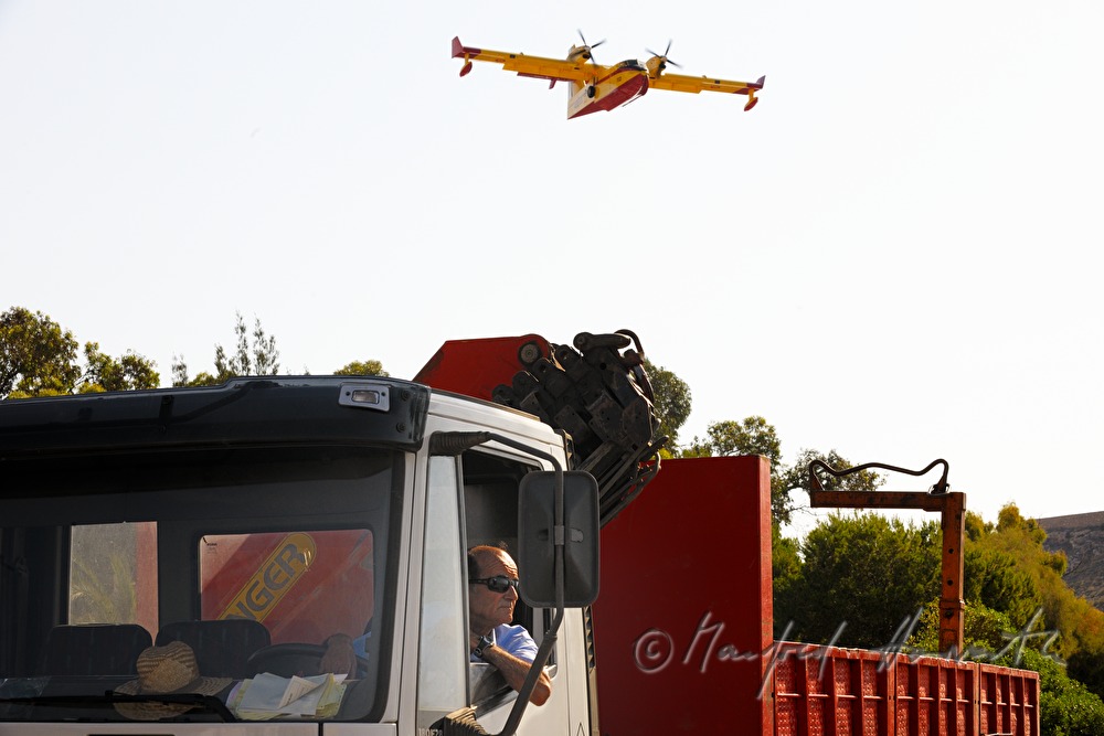 firefighting plane gliding low to take water