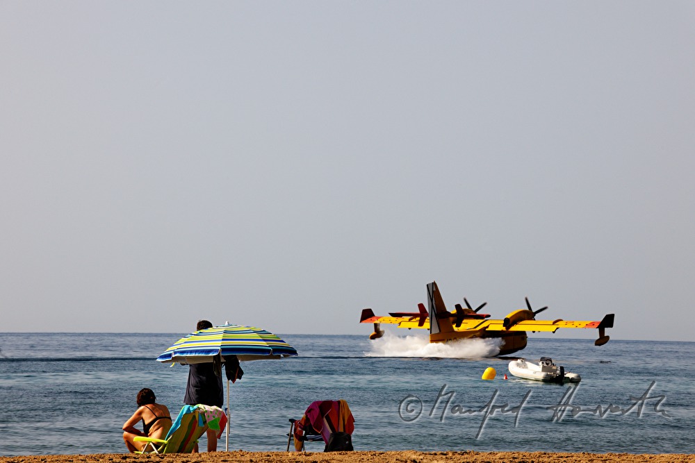 firefighting plane gliding low to take water