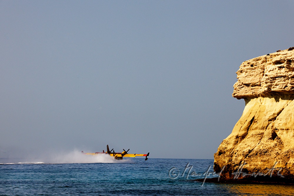 firefighting plane gliding low to take water