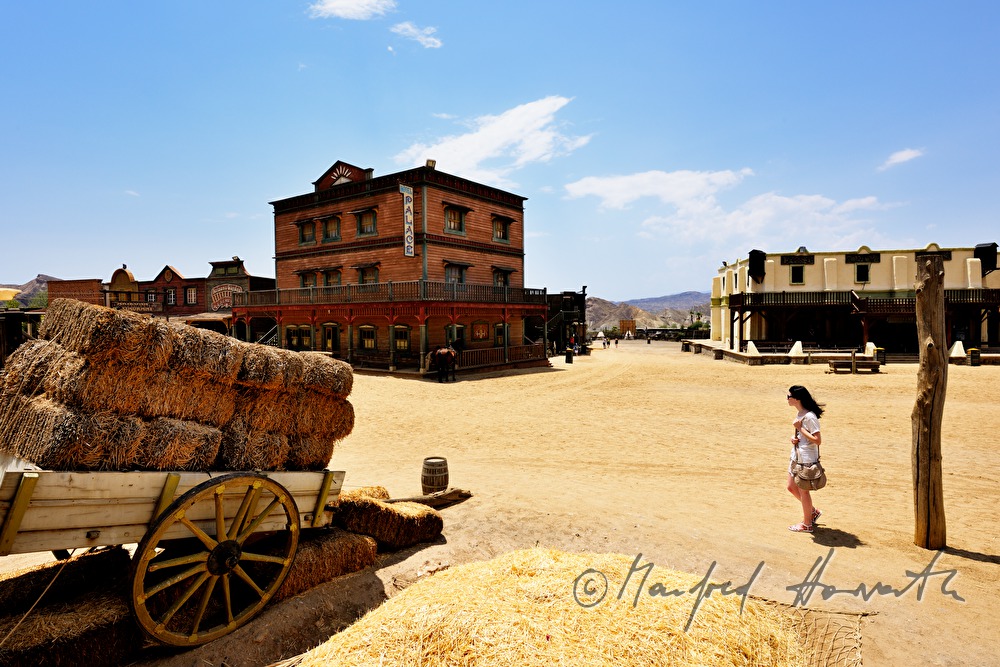 visitor crosses the square of the Wild West town