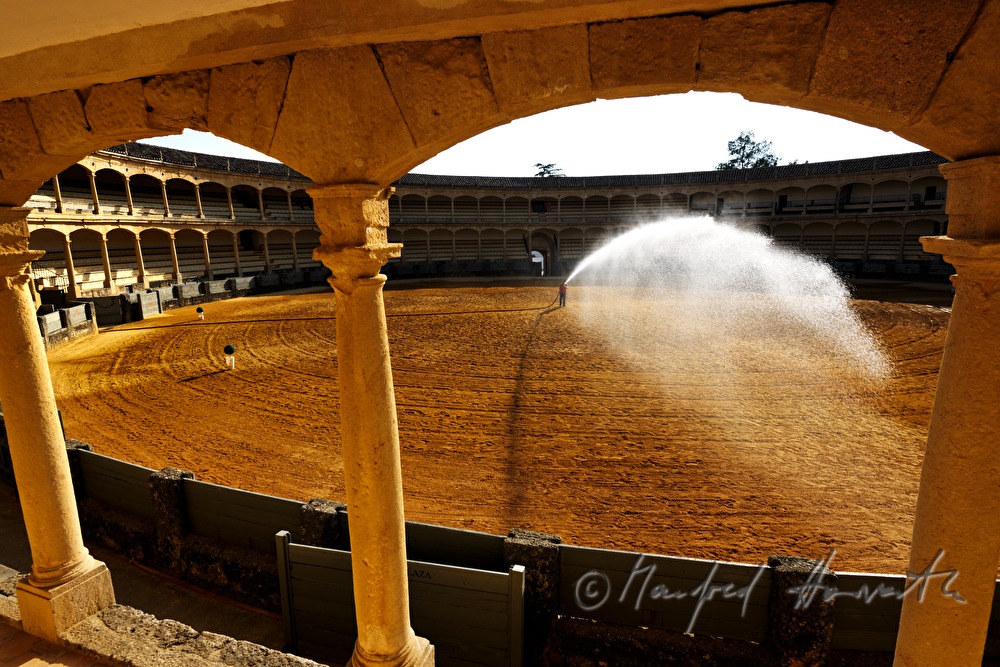employee spraying the sand before the show